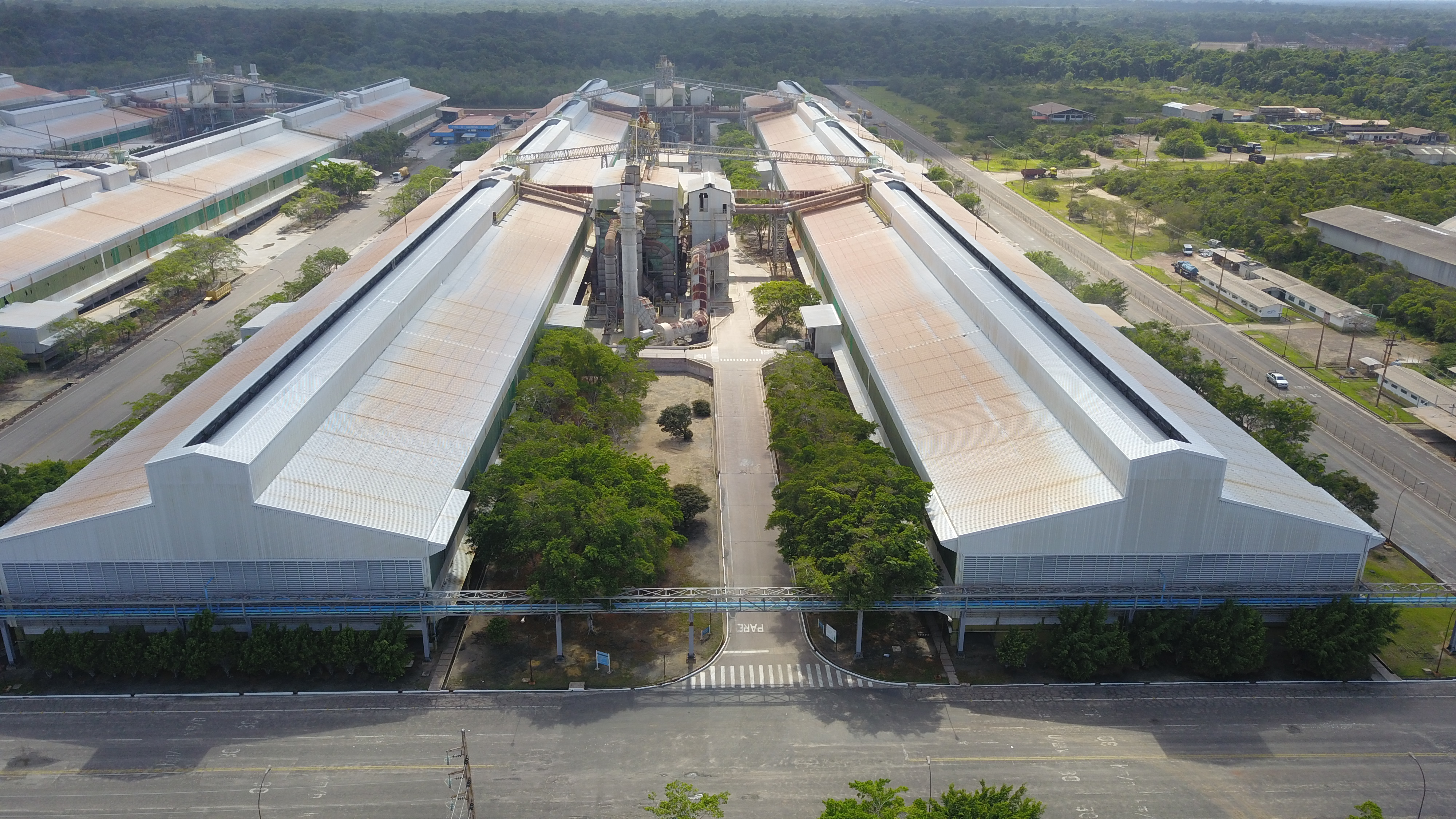 a large building with a road and trees around it