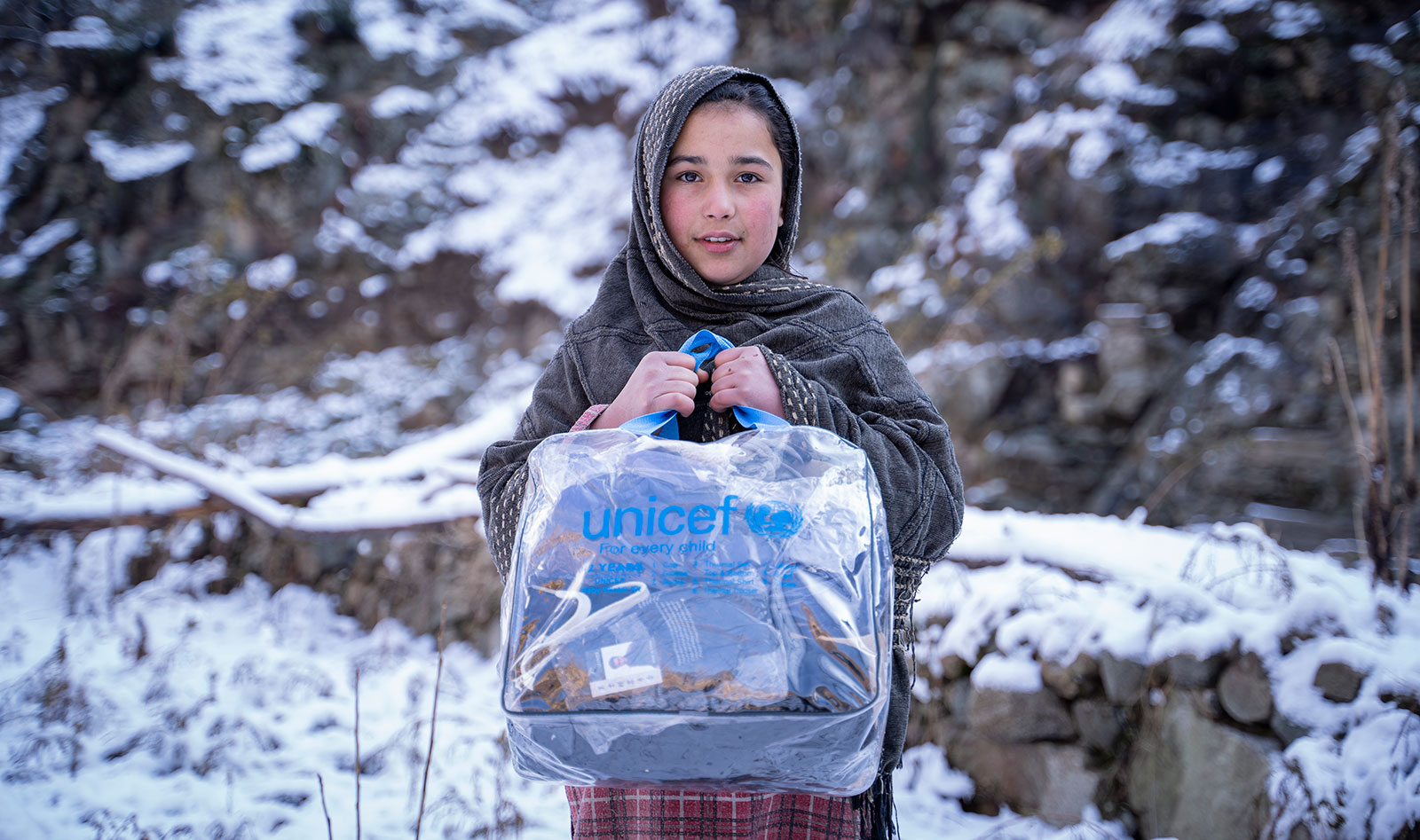 a child holding a plastic bag