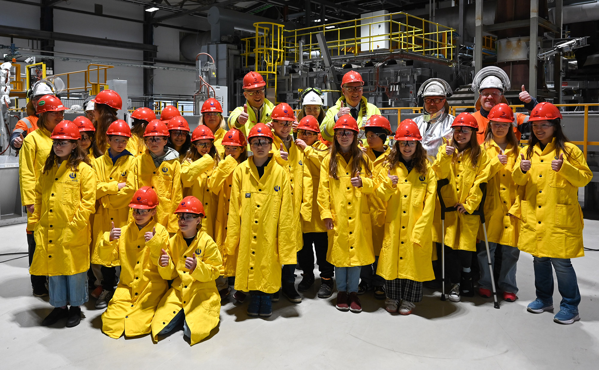 a group of people in yellow jackets