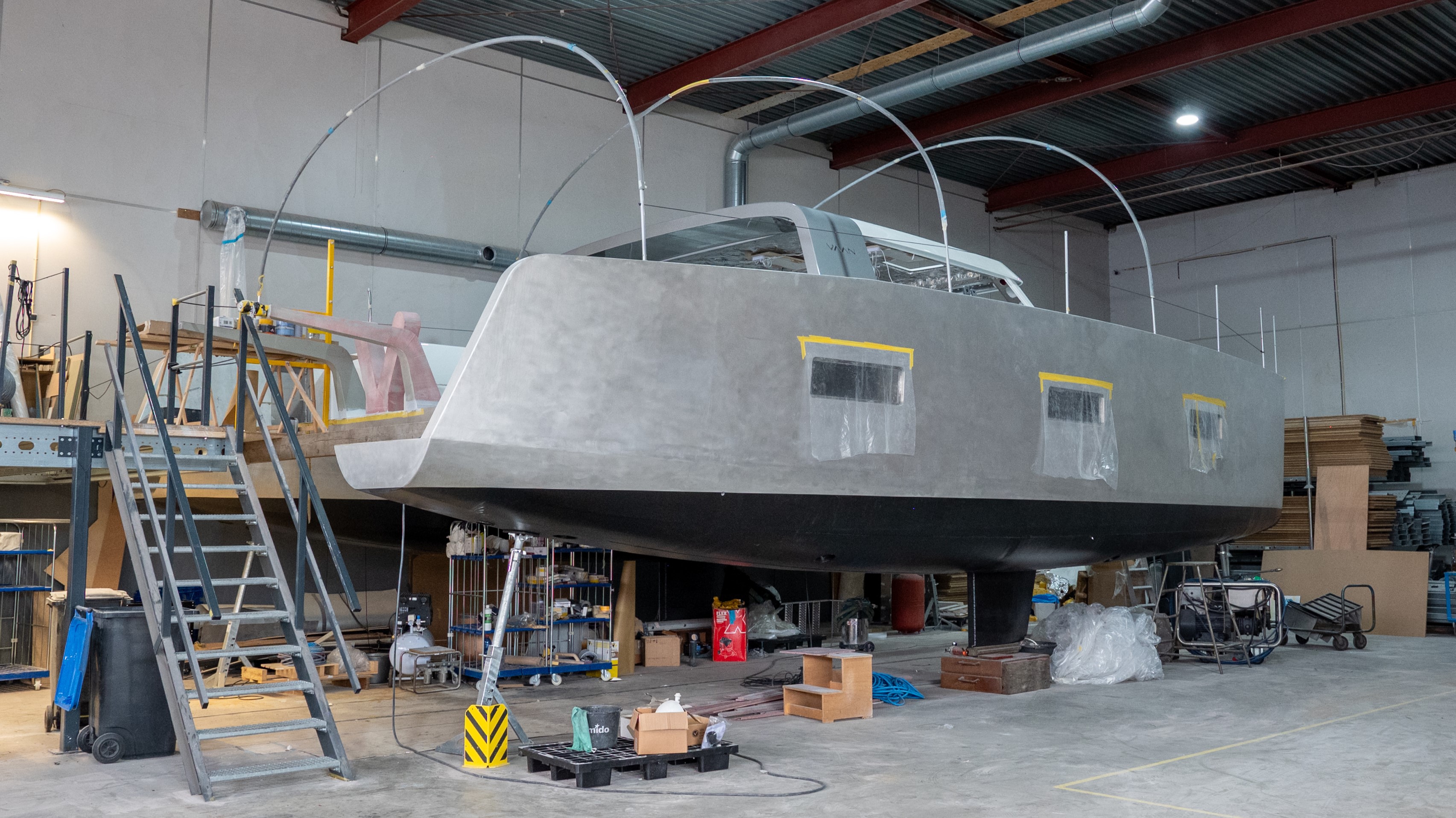 a large metal structure with ladders and boxes in a warehouse