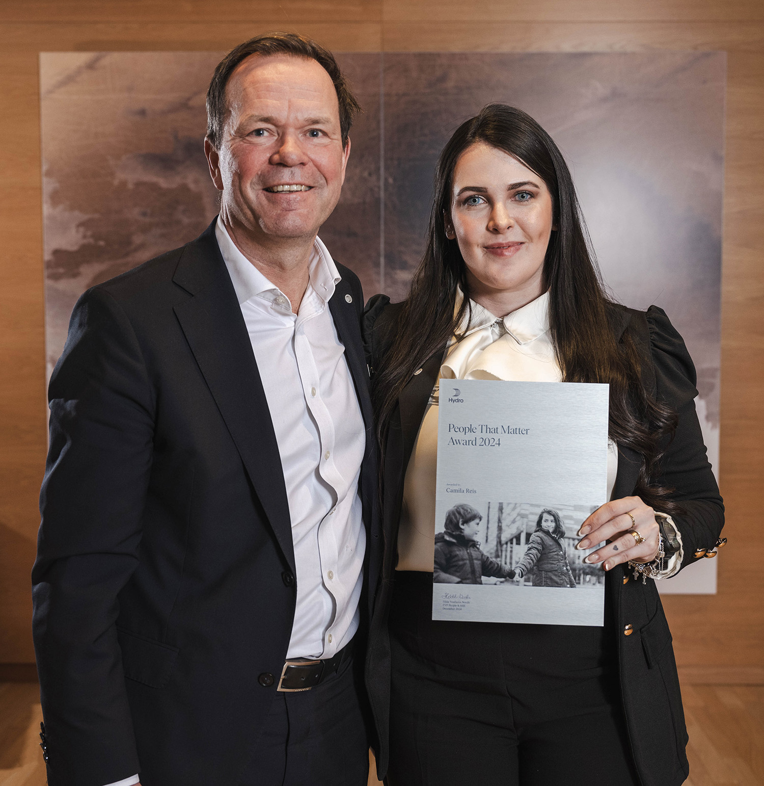a man and a woman holding a certificate