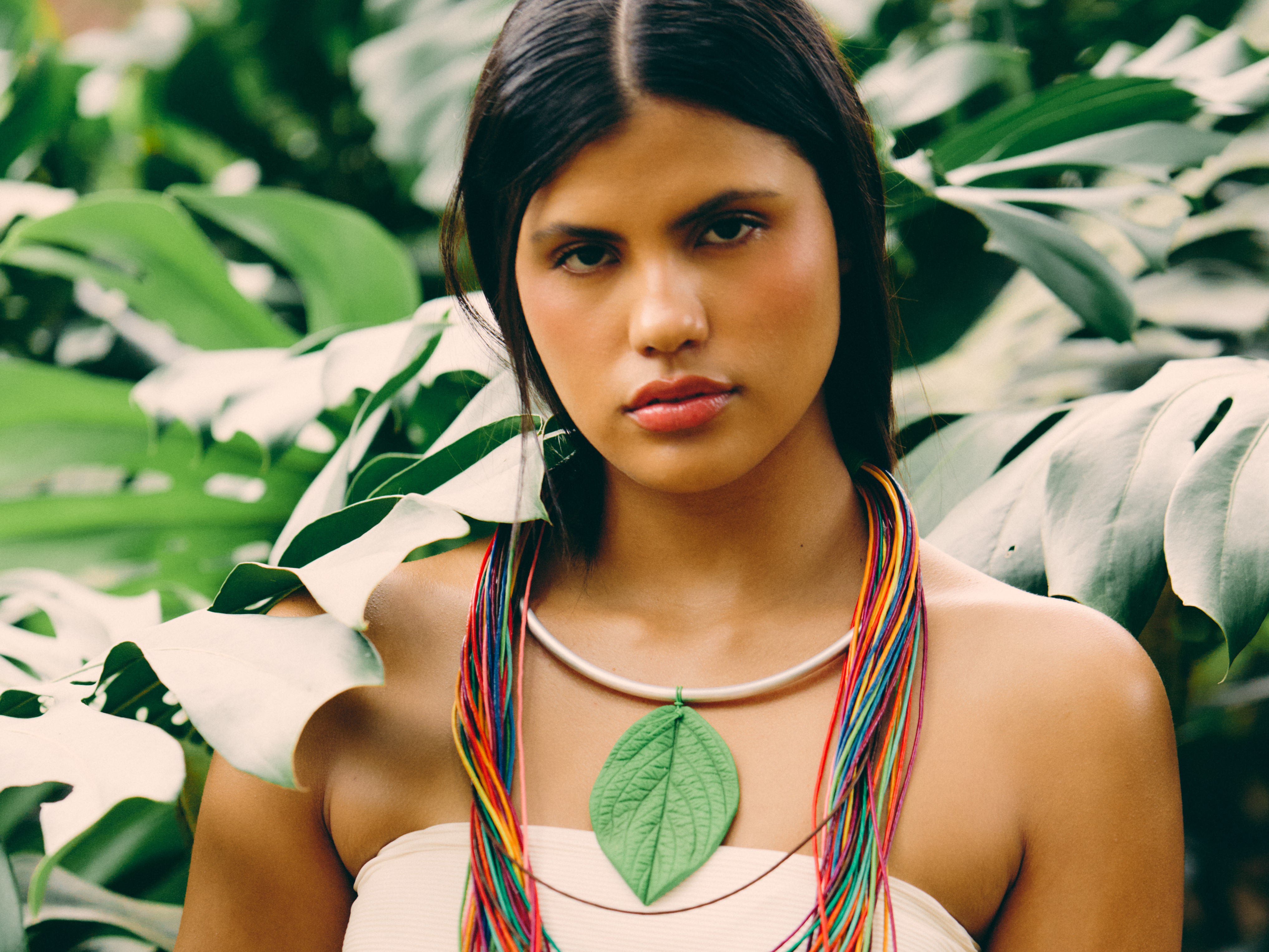 a woman with a colorful headdress and a flower in her hair