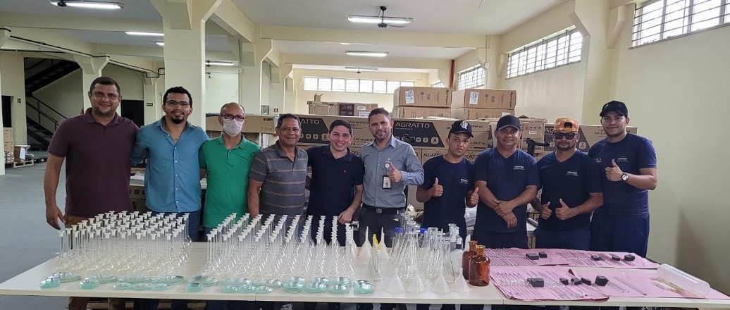 a group of people standing in a room with a table with food